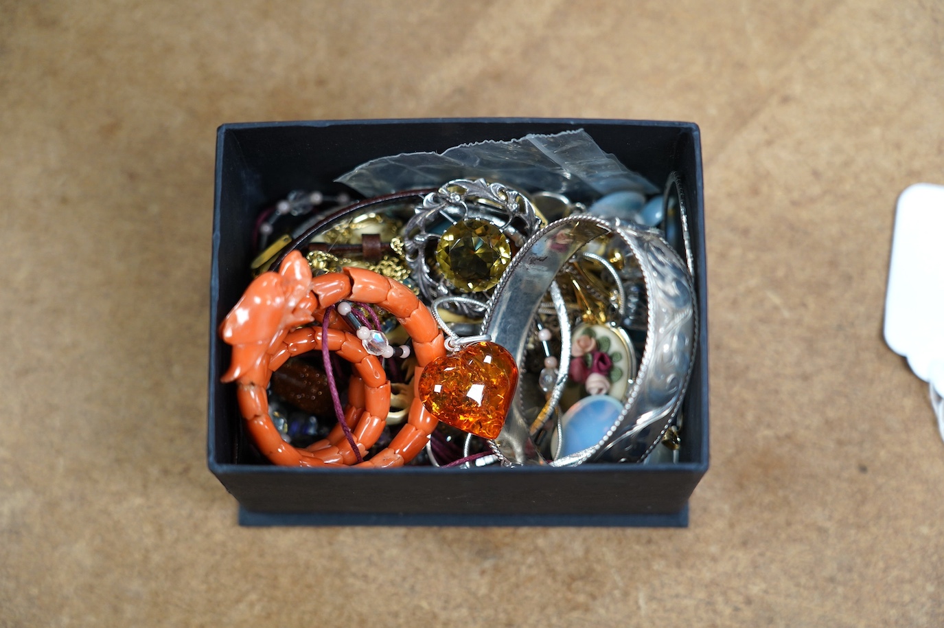 A small quantity of assorted jewellery including a coral set coiled dragon bracelet, a 1970's engraved silver hinged bangle, a Scottish silver and citrine brooch and costume. Condition - poor to fair to good